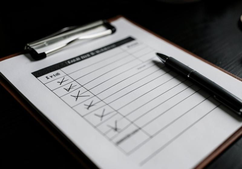 Checklist on a clipboard with a pen